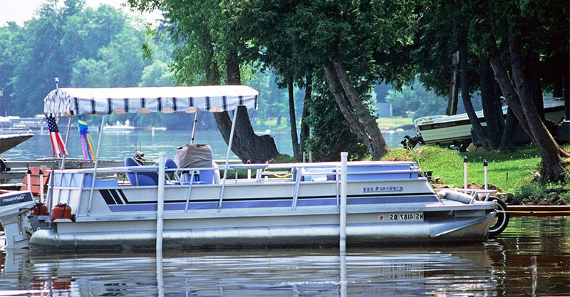 pontoon boat docked at lake